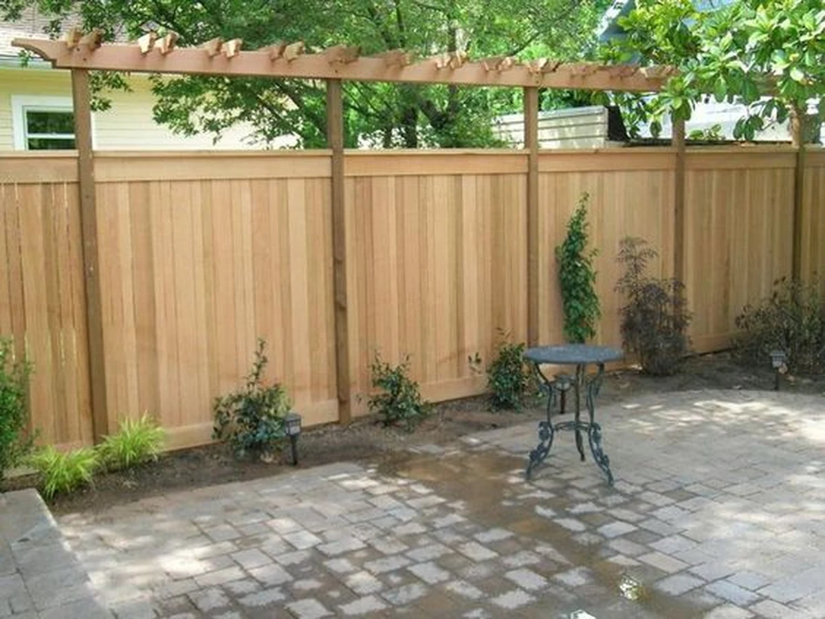 Fence painting of tall wooden garden fence in Lincoln by Lincoln Decorators, professional decorators