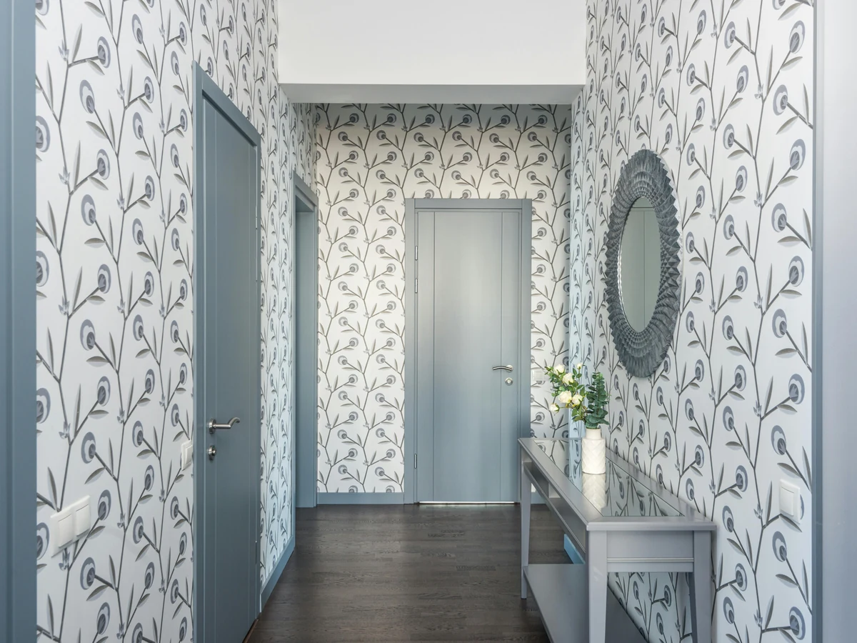 Hallway with bird pattern wallpaper hung by Lincoln Decorators