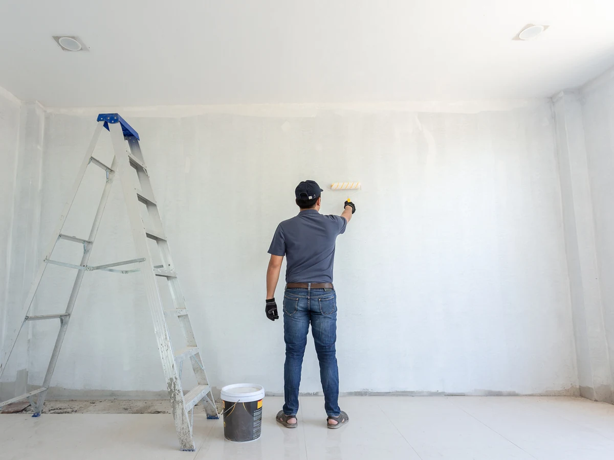 painting-decorating-man-grey-white-lincoln-decorators Lincoln Decorators painter at work on interior woodwork and doors