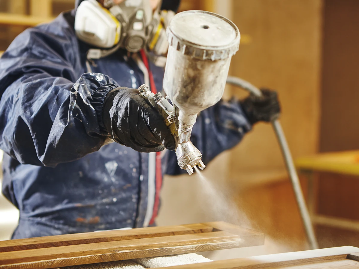 painting-decorating-worker-spray-wooden-lincoln-decorators Professional decorator preparing surfaces for plasterboard painting in Lincoln